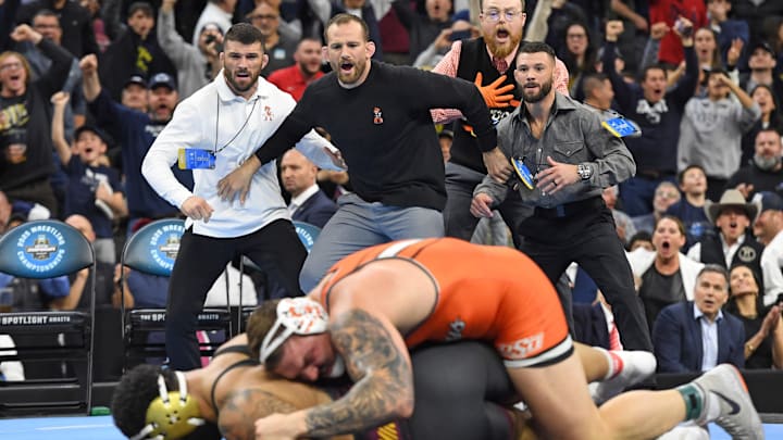 Mar 22, 2025; Philadelphia, PA, USA; Oklahoma State Cowboys coach David Taylor watches as Wyatt Hendrickson defeats Gable Steveson of the Minnesota Golden Gophers during the Division I Men's Wrestling Championship held at Wells Fargo Center. Mandatory Credit: Eric Hartline-Imagn Images
