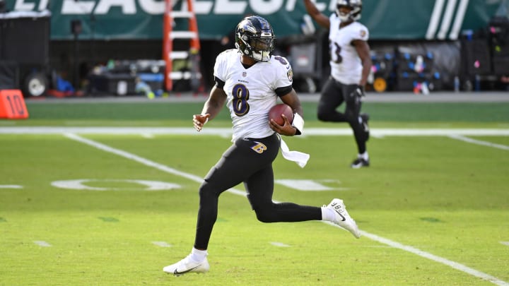Oct 18, 2020; Philadelphia, Pennsylvania, USA; Baltimore Ravens quarterback Lamar Jackson (8) looks behind him as he scores on a 37-yard touchdown run against the Philadelphia Eagles during the third quarter at Lincoln Financial Field. Mandatory Credit: Eric Hartline-USA TODAY Sports
