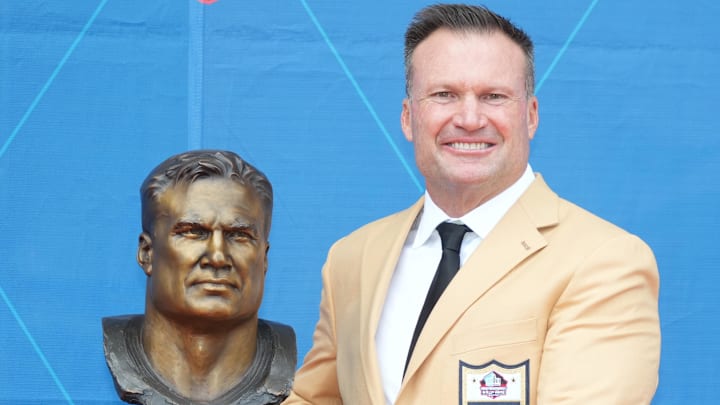 Miami Dolphins former linebacker Zach Thomas poses with his bust during the 2023 Pro Football Hall of Fame Enshrinement at Tom Benson Hall of Fame Stadium.