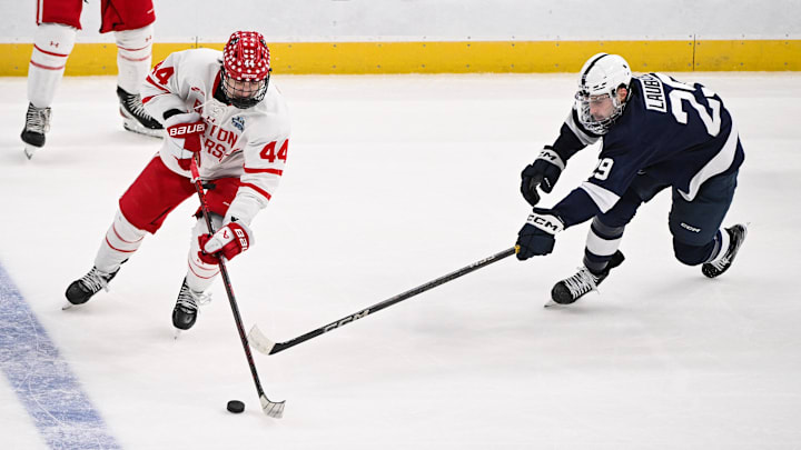 Apr 10, 2025; St. Louis, Missouri, UNITED STATES; Boston University Terriers defenseman Cole Hutson (44) controls the puck as Penn State Nittany Lions forward Reese Laubach (29) defends during the first period of the Frozen Four college ice hockey national semifinals at Enterprise Center. Mandatory Credit: Connor Hamilton-Imagn Images