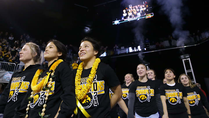 Iowa's women's wrestling team walks out of the tunnel to receive their first-place team award on Saturday, March 9, 2024, at the NCWWCs at Alliant Energy PowerHouse in Cedar Rapids, Iowa.