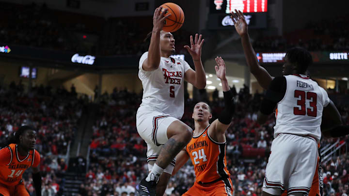 Jan 26, 2025; Lubbock, Texas, USA;  Texas Tech Red Raiders forward Darrion Williams (5) drives to the basket against Oklahoma State Cowboys forward Patrick Suemnick (24) in the first half at United Supermarkets Arena. Mandatory Credit: Michael C. Johnson-Imagn Images