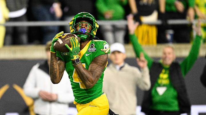 Dec 20, 2025; Eugene, OR, USA; Oregon Ducks wide receiver Malik Benson (4) makes a catch for a touchdown during the second quarter against the James Madison Dukes at Autzen Stadium. Dec 20, 2025; Eugene, OR, USA; Oregon Ducks wide receiver Malik Benson (4) makes a catch for a touchdown during the second quarter against the James Madison Dukes at Autzen Stadium.