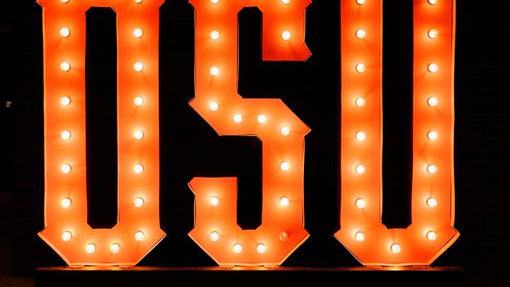 Lighted Oklahoma State logo in the lobby of an arena.