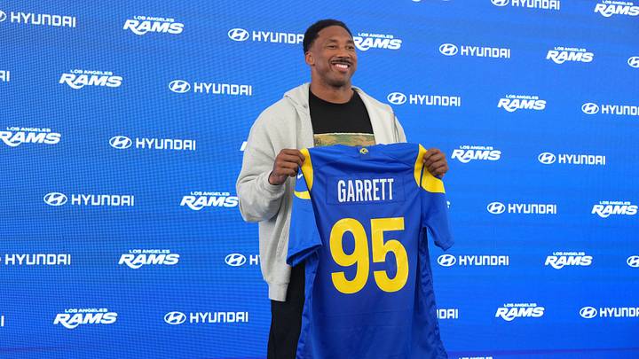 Jun 2, 2026; Woodland Hills, CA, USA; Los Angeles Rams defensive end Myles Garrett (95) poses with jersey at press conference at Rams Practice Facility. Mandatory Credit: Kirby Lee-Imagn Images
