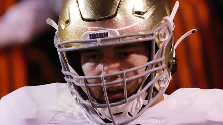 Notre Dame football offensive lineman Tosh Baker (79) stands on the field during warmups prior to the game against the Virginia Cavaliers at Scott Stadium. 
