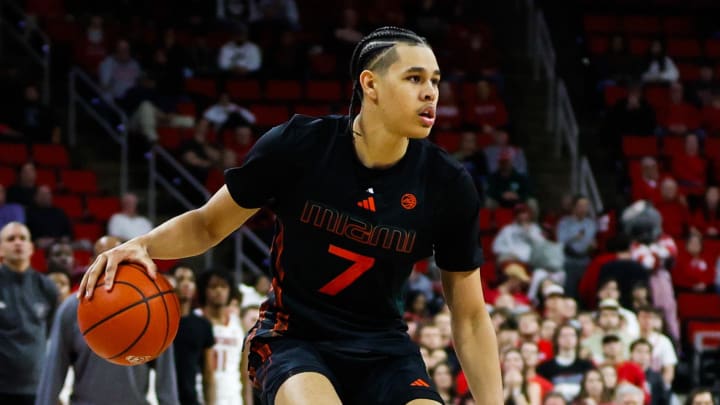 Jan 30, 2024; Raleigh, North Carolina, USA; Miami (Fl) Hurricanes guard Kyshawn George (7) dribbles with the ball during the second half against North Carolina State Wolfpack at PNC Arena. Mandatory Credit: Jaylynn Nash-USA TODAY Sports