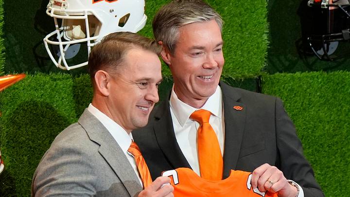 OSU Athletic Director Chad Weiberg presents a jersey to Eric Morris.