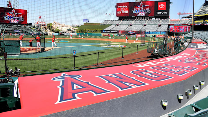 Apr 7, 2022; Anaheim, California, USA; Workers put finishing touches on the field as players warm up for the opening day game between the Los Angeles Angels and the Houston Astros at Angel Stadium. Mandatory Credit: Jayne Kamin-Oncea-Imagn Images Apr 7, 2022; Anaheim, California, USA; Workers put finishing touches on the field as players warm up for the opening day game between the Los Angeles Angels and the Houston Astros at Angel Stadium. Mandatory Credit: Jayne Kamin-Oncea-Imagn Images