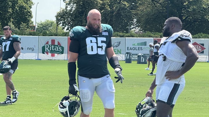 Lane Johnson and Moro Ojomo discuss a drill during Eagles training camp. Lane Johnson and Moro Ojomo discuss a drill during Eagles training camp.