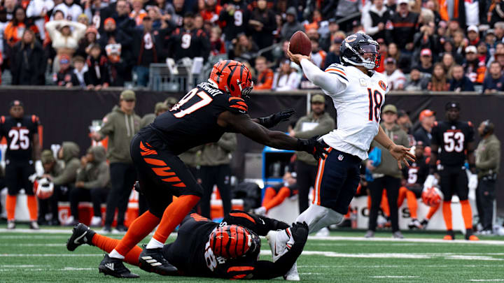 Cincinnati Bengals defensive tackle T.J. Slaton Jr. (98) and Cincinnati Bengals defensive end Shemar Stewart (97) force Chicago Bears quarterback Caleb Williams (18) to throw the ball away in the second quarter of the NFL football game between Chicago Bears and Cincinnati Bengals at Paycor Stadium in Cincinnati on Nov. 2, 2025.