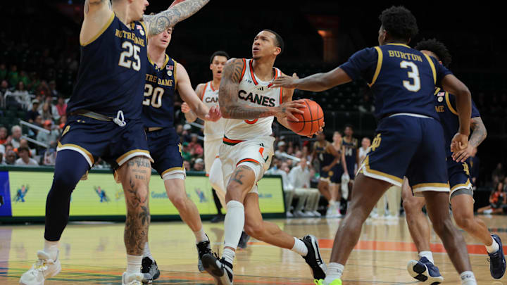 Feb 1, 2025; Coral Gables, Florida, USA; Miami Hurricanes guard Matthew Cleveland (0) drives to the basket against Notre Dame Fighting Irish forward Nikita Konstantynovskyi (25), guard J.R. Konieczny (20) and guard Markus Burton (3) during the second half at Watsco Center. Mandatory Credit: Sam Navarro-Imagn Images
