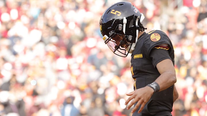 Dec 1, 2024; Landover, Maryland, USA; Washington Commanders quarterback Jayden Daniels (5) celebrates after scoring a touchdown against the Tennessee Titans during the first half at Northwest Stadium. Mandatory Credit: Amber Searls-Imagn Images