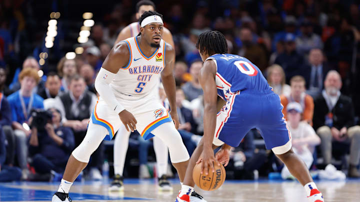 Nov 25, 2023; Oklahoma City, Oklahoma, USA; Oklahoma City Thunder guard Luguentz Dort (5) defends Philadelphia 76ers guard Tyrese Maxey (0) during the second half at Paycom Center. Mandatory Credit: Alonzo Adams-Imagn Images