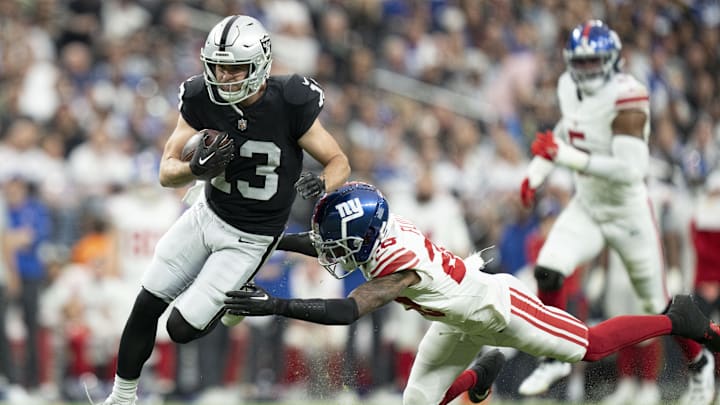 November 5, 2023; Paradise, Nevada, USA; Las Vegas Raiders wide receiver Hunter Renfrow (13) is tackled by New York Giants cornerback Cor'Dale Flott (28) during the second quarter at Allegiant Stadium. Mandatory Credit: Kyle Terada-Imagn Images
