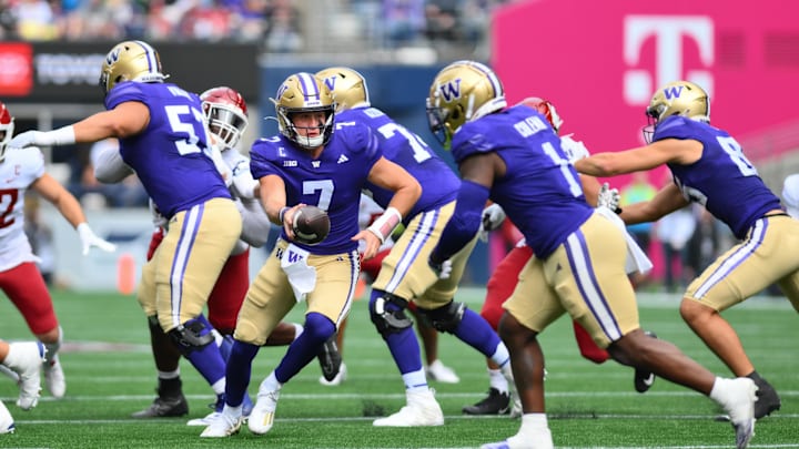 Sep 14, 2024; Seattle, Washington, USA; Washington Huskies quarterback Will Rogers (7) hands the ball off to Washington Huskies running back Jonah Coleman (1) during the first half against the Washington State Cougars at Lumen Field. Mandatory Credit: Steven Bisig-Imagn Images