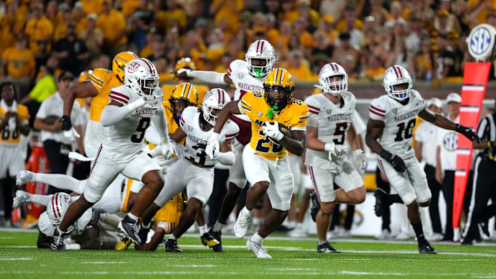 Missouri Tigers running back Ahmad Hardy (29) runs away from several defenders, in a game versus the UMass Minutemen this season.