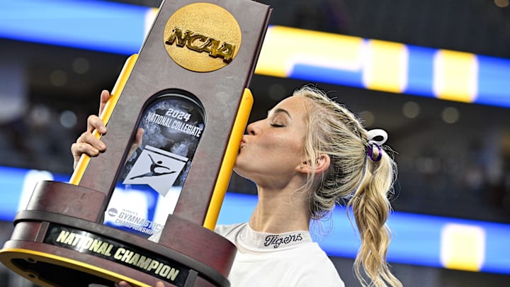 LSU gymnast Olivia Dunne kisses the championship trophy after the Tigers gymnastics team wins the national championship in the 2024 Women's National Gymnastics Championship. LSU gymnast Olivia Dunne kisses the championship trophy after the Tigers gymnastics team wins the national championship in the 2024 Women's National Gymnastics Championship.