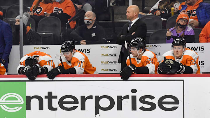 Jan 24, 2022; Philadelphia, Pennsylvania, USA; Philadelphia Flyers interim head coach Mike Yeo, right, stands behind his team as time runs out in a loss to the Dallas Stars during the third period at Wells Fargo Center.