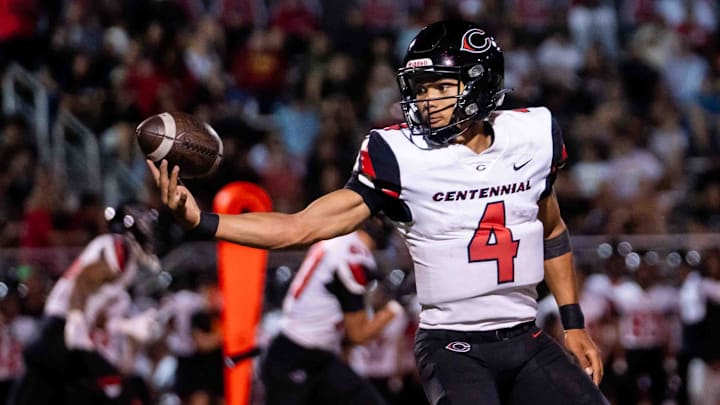Centennial Huskies Quarterback Husan Longstreet (4) catches the ball at Liberty High School on Sept. 21, 2024, in Peoria. Centennial Huskies Quarterback Husan Longstreet (4) catches the ball at Liberty High School on Sept. 21, 2024, in Peoria.