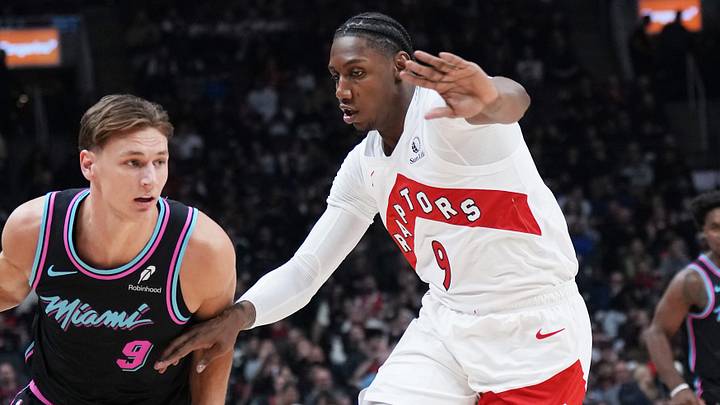 Apr 7, 2026; Toronto, Ontario, CAN; Miami Heat guard Pelle Larsson (9) controls the ball as Toronto Raptors forward RJ Barrett (9) defends during the first quarter at Scotiabank Arena. Mandatory Credit: Nick Turchiaro-Imagn Images