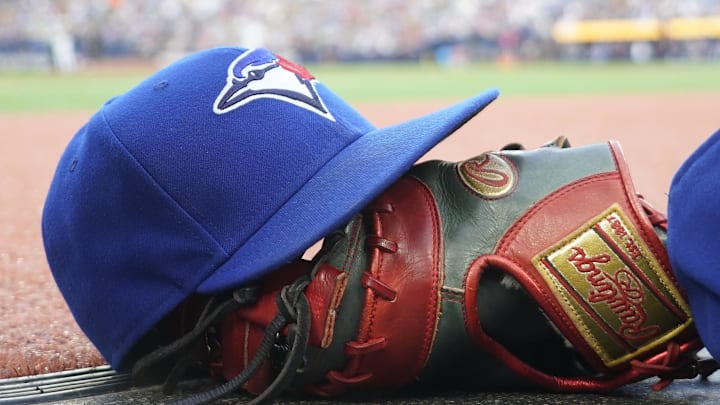 Jul 26, 2024; Toronto, Ontario, CAN; A Toronto Blue Jays hat and glove outside of the dugout during a game against the Texas Rangers at Rogers Centre. Mandatory Credit: John E. Sokolowski-Imagn Images