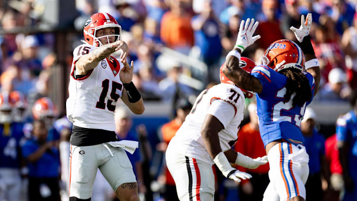 Georgia Bulldogs quarterback Carson Beck (15) throws over the hands of Florida Gators cornerback Jaydon Hill (23) during the first half at Everbank Stadium in Jacksonville, FL on Saturday, October 28, 2023. [Matt Pendleton/Gainesville Sun]