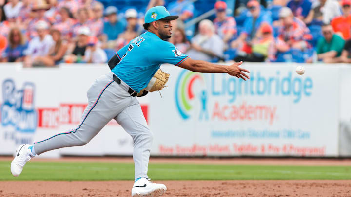 Feb 21, 2026; Port St. Lucie, Florida, USA; Miami Marlins first baseman Christopher Morel (5) tosses the ball to relief pitcher Tyler Phillips (not pictured) to retire New York Mets first baseman Jose Rojas (not pictured) during the third inning at Clover Park. 
