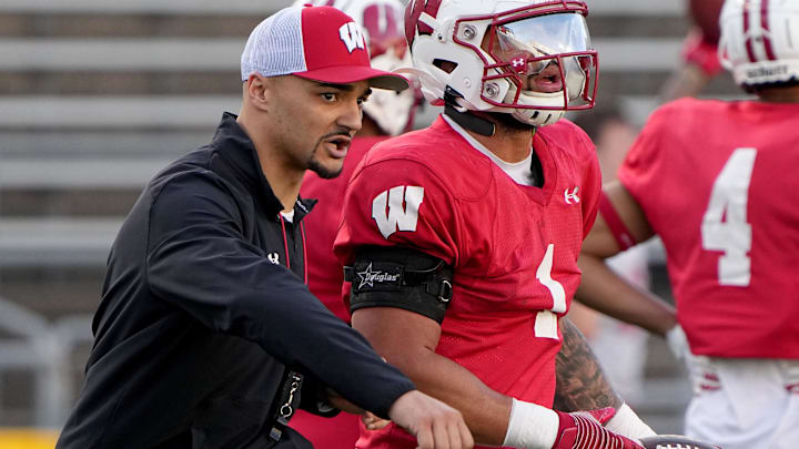 Apr 11, 2023; Madison, WI, USA; Wisconsin running backs coach Devon Spalding talks with running back Chez Mellusi (1) during practice Tuesday, April 11, 2023 at Camp Randall Stadium in Madison, Wis. 
