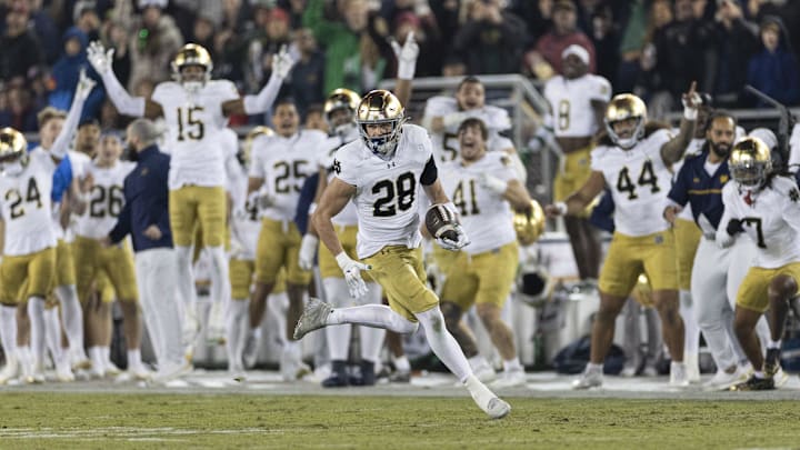 Nov 29, 2025; Stanford, California, USA;   Notre Dame Fighting Irish safety Luke Talich (28) runs for a touchdown on a fake punt against the Stanford Cardinal during the second quarter at Stanford Stadium. Mandatory Credit: Stan Szeto-Imagn Images
