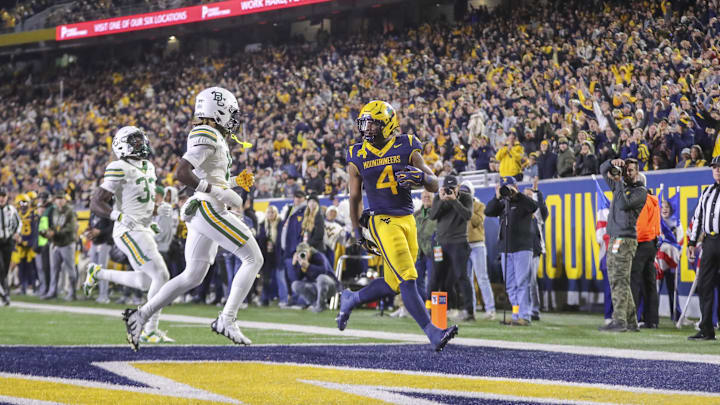 Nov 16, 2024; Morgantown, West Virginia, USA; West Virginia Mountaineers running back CJ Donaldson Jr. (4) runs the ball for a touchdown during the second quarter against the Baylor Bears at Mountaineer Field at Milan Puskar Stadium. Mandatory Credit: Ben Queen-Imagn Images