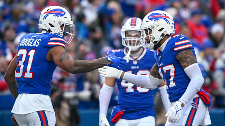Dec 31, 2023; Orchard Park, New York, USA; Buffalo Bills cornerback Rasul Douglas (31) and cornerback Christian Benford (47) celebrate a turnover against the New England Patriots with linebacker Terrel Bernard (43) in the first quarter at Highmark Stadium.