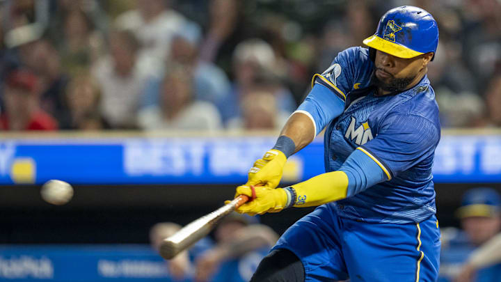 Minnesota Twins first baseman Carlos Santana hits a single during a game against the Cincinnati Reds on Sept. 13 at Target Field.