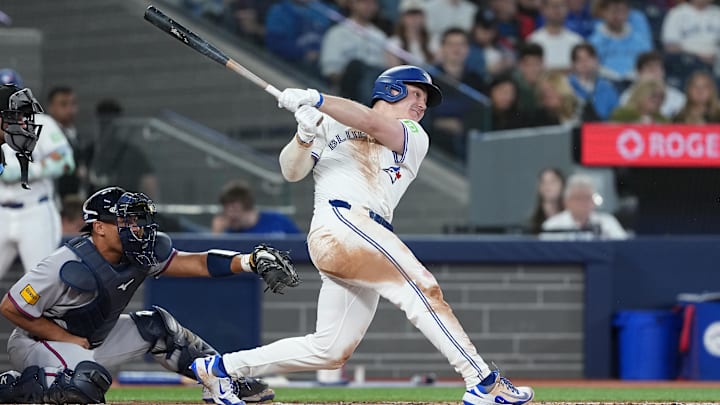 Apr 15, 2025; Toronto, Ontario, CAN; Toronto Blue Jays outfielder Alan Roden (18) hits a two-run home run against the Atlanta Braves during the fifth inning at Rogers Centre. All players wore #42 for Jackie Robinson Day. 
