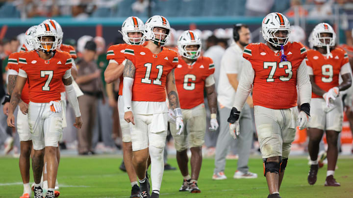 Sep 20, 2025; Miami Gardens, Florida, USA; Miami Hurricanes quarterback Carson Beck (11) and his teammates walk toward the line of scrimmage against the Florida Gators during the fourth quarter at Hard Rock Stadium. Mandatory Credit: Sam Navarro-Imagn Images Sep 20, 2025; Miami Gardens, Florida, USA; Miami Hurricanes quarterback Carson Beck (11) and his teammates walk toward the line of scrimmage against the Florida Gators during the fourth quarter at Hard Rock Stadium. Mandatory Credit: Sam Navarro-Imagn Images