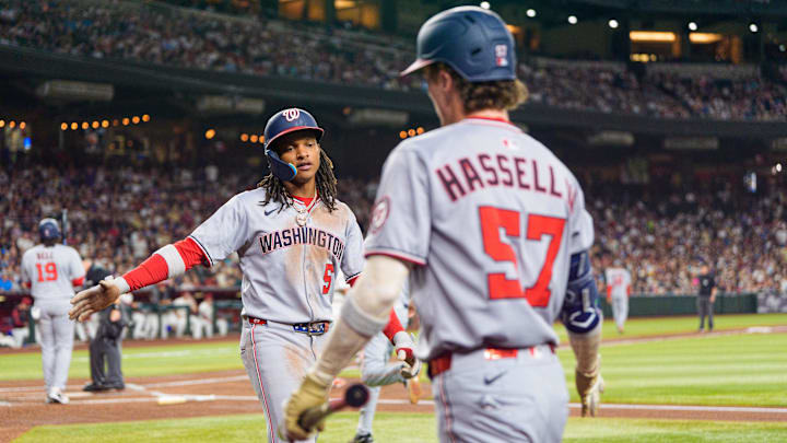 May 31, 2025; Phoenix, Arizona, USA;  Washington Nationals infielder CJ Abrams (5) and outfielder Robert Hassell III (57) celebrate after Abrams scores in the first inning against the Arizona Diamondbacks at Chase Field.