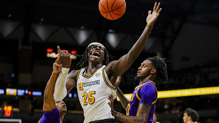 Jan 7, 2025; Columbia, Missouri, USA; Missouri Tigers guard Mark Mitchell (25) loses control of the ball against LSU Tigers guard Jordan Sears (1) and forward Daimion Collins (10) during the first half at Mizzou Arena. Mandatory Credit: Jay Biggerstaff-Imagn Images