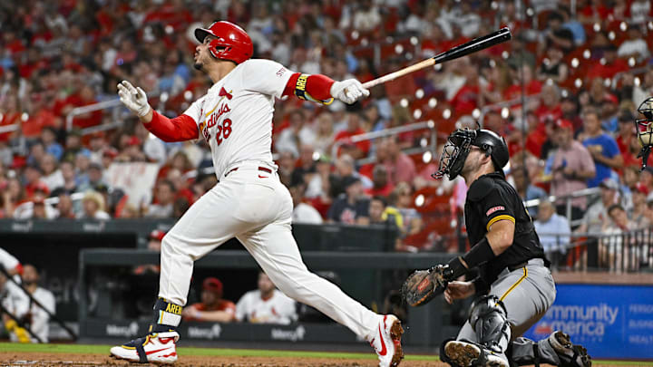 Sep 18, 2024; St. Louis, Missouri, USA;  St. Louis Cardinals third baseman Nolan Arenado (28) hits a one run single against the Pittsburgh Pirates during the third inning at Busch Stadium. 