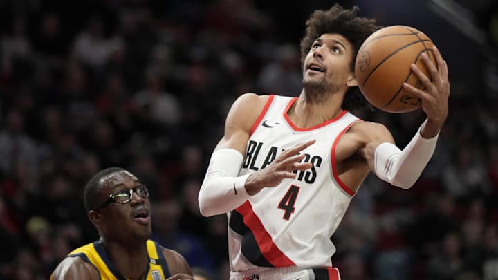 Jan 19, 2024; Portland, Oregon, USA; Portland Trail Blazers shooting guard Matisse Thybulle (4) shoots the ball against Indiana Pacers power forward Jalen Smith (25, left) during the second half at Moda Center. Mandatory Credit: Soobum Im-Imagn Images