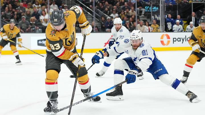 Vegas Golden Knights' Mitch Marner (93) battles for the puck with Tampa Bay Lightning defenseman Erik Cernak (81) in the first period at T-Mobile Arena.  Mandatory Credit: Candice Ward-Imagn Images