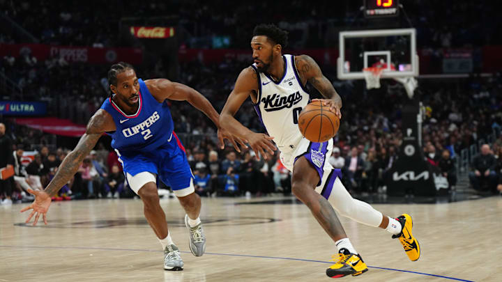 Dec 6, 2023; Los Angeles, California, USA; Sacramento Kings guard Malik Monk (0) dribbles the ball against LA Clippers forward Kawhi Leonard (2) in the second half at Crypto.com Arena. Mandatory Credit: Kirby Lee-Imagn Images