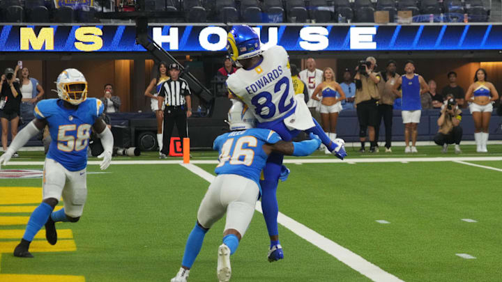 Aug 16, 2025; Inglewood, California, USA; Los Angeles Rams wide receiver Tru Edwards (82) catches an 8-yard touchdown pass against Los Angeles Chargers cornerback Nikko Reed (46) and linebacker Bud Dupree (48) in the fourth quarter at SoFi Stadium. Mandatory Credit: Kirby Lee-Imagn Images