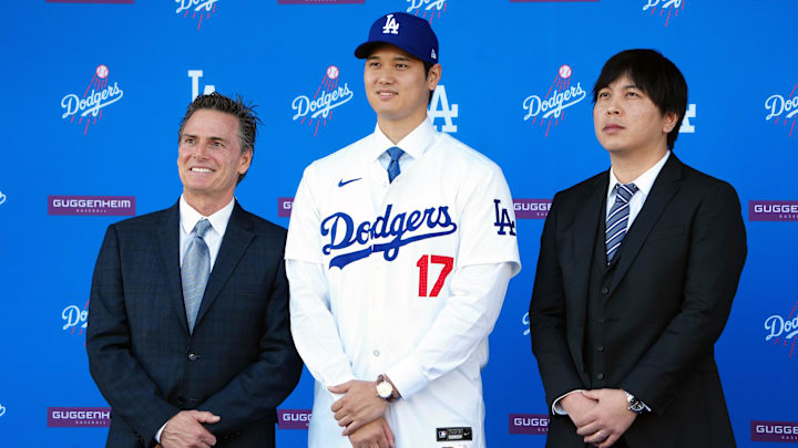 Dec 14, 2023; Los Angeles, CA, USA; Los Angeles Dodgers player Shohei Ohtani stands with his agent Nez Balelo (left) and interpreter Ippei Mizuhara at an introductory press conference at Dodger Stadium. Mandatory Credit: Kirby Lee-Imagn Images