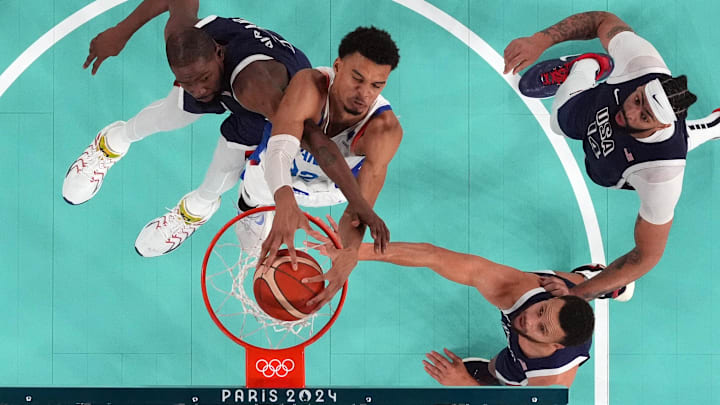 Aug 10, 2024; Paris, France; France power forward Victor Wembanyama (32) shoots against United States guard Kevin Durant (7) and shooting guard Stephen Curry (4) in the second half in the men's basketball gold medal game during the Paris 2024 Olympic Summer Games at Accor Arena. Mandatory Credit: Kyle Terada-Imagn Images