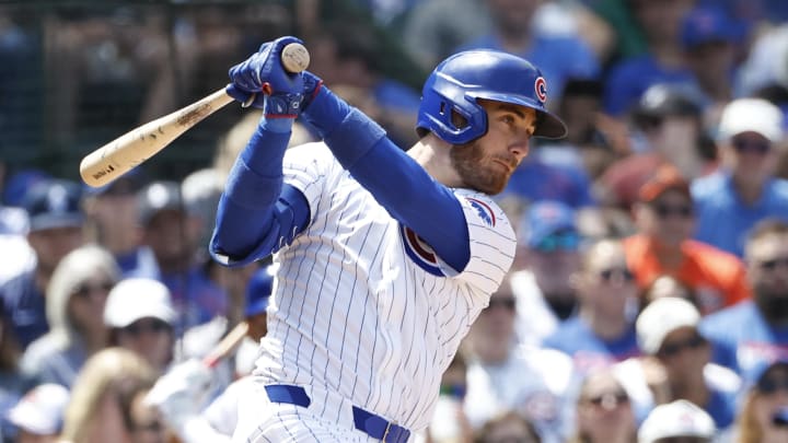 Jun 2, 2024; Chicago, Illinois, USA; Chicago Cubs outfielder Cody Bellinger (24) hits an RBI single against the Cincinnati Reds during the fifth inning at Wrigley Field.