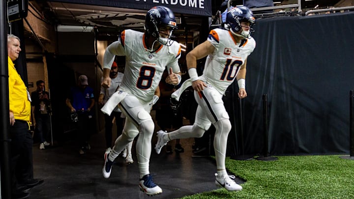 Oct 17, 2024; New Orleans, Louisiana, USA;  Denver Broncos quarterback Jarrett Stidham (8) and quarterback Bo Nix (10) run out the tunnel during the warmups before the game against the New Orleans Saints at Caesars Superdome. Mandatory Credit: Stephen Lew-Imagn Images