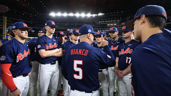Ole Miss baseball coach Mike Bianco talks to players before the game against the Texas Longhorns at the Shriners Children's College Showdown in Arlington, Texas.