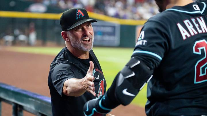 Aug 10, 2026; Phoenix, Arizona, USA; Arizona Diamondbacks manager Torey Lovullo (left) celebrates with third baseman Nolan Arenado after hitting a grand slam home run in the first inning against the Colorado Rockies at Chase Field. Mandatory Credit: Mark J. Rebilas-Imagn Images