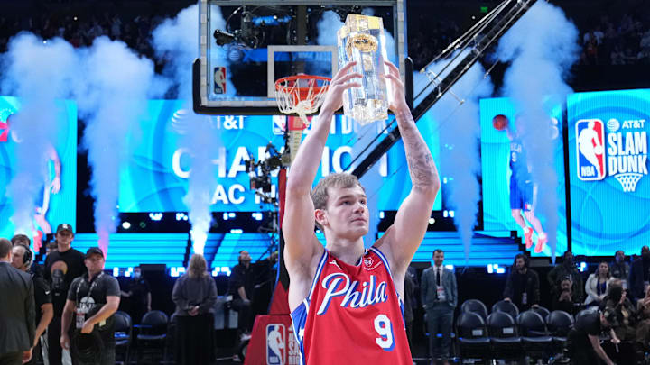 Feb 18, 2023; Salt Lake City, UT, USA; Philadelphia 76ers guard Mac McClung (9) celebrates with the trophy after winning the Dunk Contest during the 2023 All Star Saturday Night at Vivint Arena. Mandatory Credit: Kyle Terada-Imagn Images