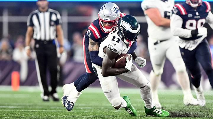 Sep 10, 2023; Foxborough, Massachusetts, USA; Philadelphia Eagles wide receiver A.J. Brown (11) is tackled by New England Patriots cornerback Christian Gonzalez (6) during the second half at Gillette Stadium. Mandatory Credit: Brian Fluharty-Imagn Images